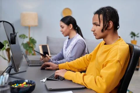 Two young people writing code in office black man in foreground Stock Photos