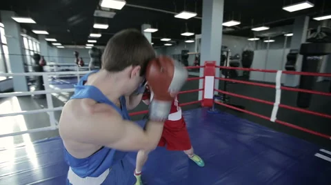 Two young professional boxers are fighting on the boxing ring. Steadicam shot Stock Footage 57973612