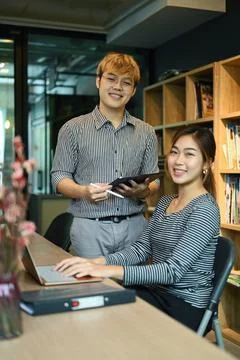 Two young professional it developer working together in modern corporate office Stock Photos