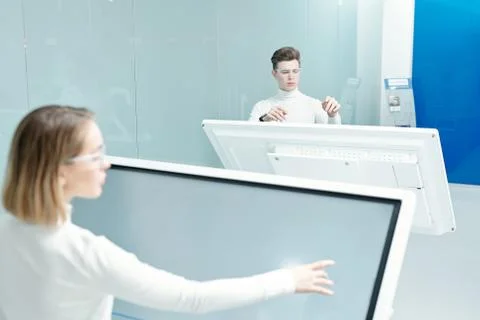 Two young progressive software developers looking through database Stock Photos