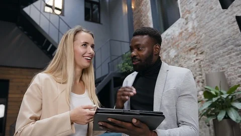 Two young responsible prospective colleagues working together in the office Stock Footage 121760341