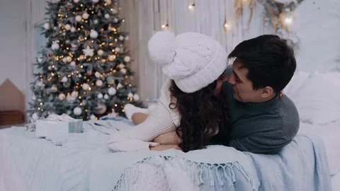 Two young romantic and cheerful girl and boy have fun on the bed Video stock 142735474