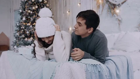 Two young romantic and cheerful girl and boy have fun on the bed. Beautifully 库存影片 143344225