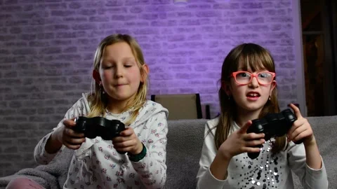 Two young sisters playing video games together at home Stock-Footage 148881996