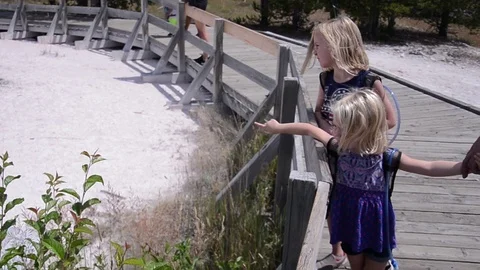 Two young sisters pointing at geyser Stock Footage 94684752