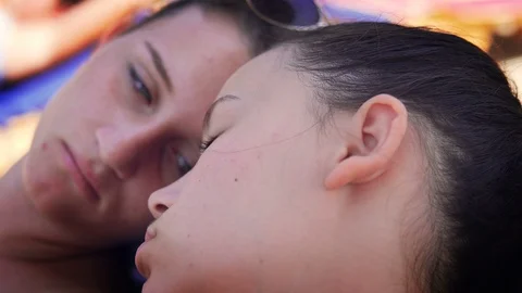 Two young sleepy teens having fun on beach sleeping Stock Footage 102237269