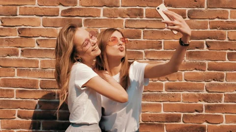 Two young smiling hipster blond women Stock Footage 141240692