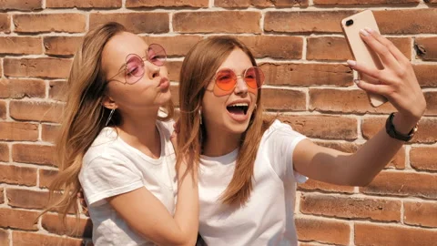Two young smiling hipster blond women Stock Footage 141240952