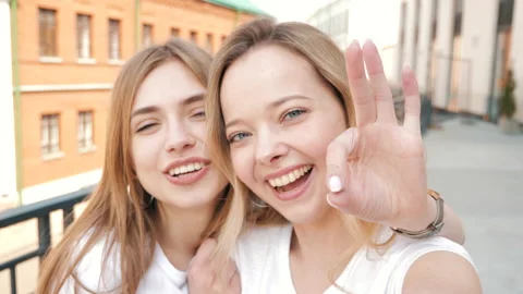 Two young smiling hipster blond women Stockbeeldmateriaal 141243832