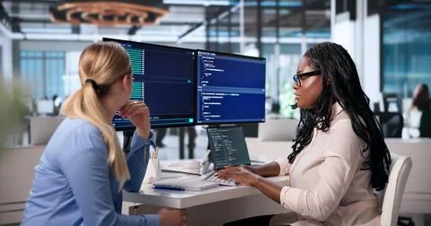 Two Young Software Developers Collaborate Remotely On Coding Projects Togethe Stock-Fotos