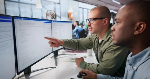 Two Young Software Engineers Work Together Coding Secure Web Applications. Stock Photos
