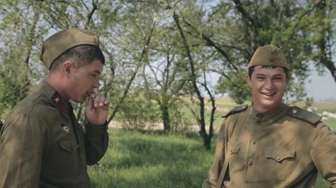 Two young soldier in uniform standing in the forest and smoke Stock Footage 50876937