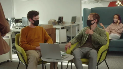 Two young students are discussing about their teamwork and the project, sitting Stock Footage 175506231