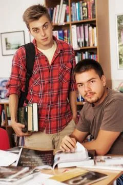 Two young students working and studying in a college library Stock Photos
