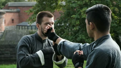 Two young warrior focused attention at practicing kung fu skills for self-defens Video stock 199492563