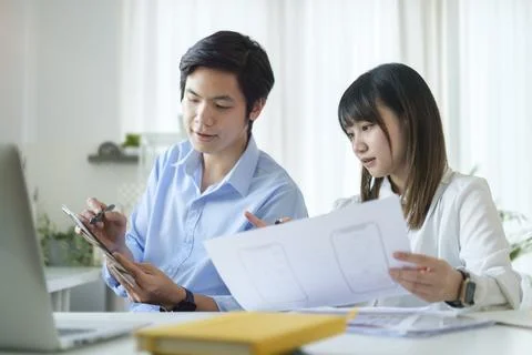 Two young web application developer working on design project for mobile ap.. Stock Photos