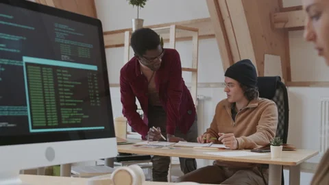 Two Young Web Designers Talking while Woman Coding Stock Footage 143326481