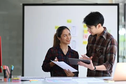 Two young web developers are working together for mobile application software Stock Photos