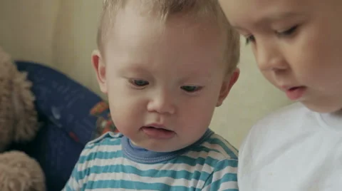 Two young white kids playing with a tablet. Stock Footage 61475188