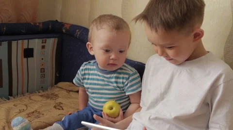 Two young white kids playing with a tablet. Stock Footage 61475417
