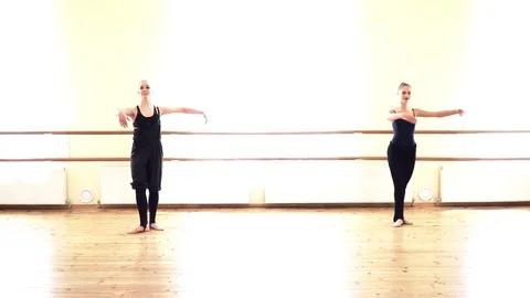 Two young women dancing in the dancing studio near the bare Stock Footage 76124923