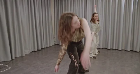 Two Young Women Dancing a Modern Contemporary Routine in a Studio with Gray Video stock 312360341