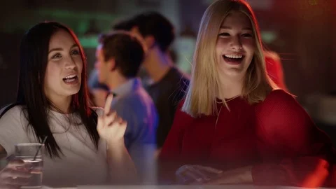 Two young women ordering drinks in bar Stock Footage 84466528