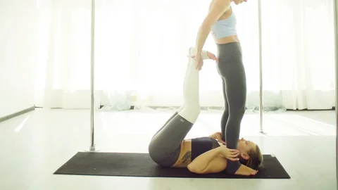 Two young women practicing acrobatic yoga. Video stock 88615969