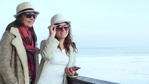 Two young women standing on the lighthouse. travel and leisure Stock Footage