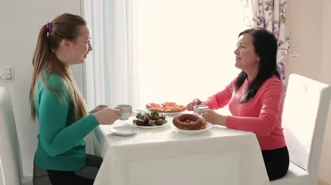 Two young women talking over coffee. Breakfast two young woman. Young woman Stock Footage 61754947