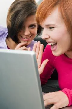 Two young women using a laptop Stock Photos