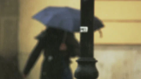 Two Young Women Walking With Umbrellas in the Rain Stock Footage 88024214