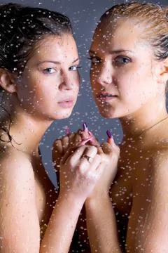 Two young women with water droplets Stock Photos