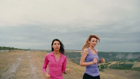 Two Young women's runner training in summer park. Close up fitness woman jogg Stock-Footage 138989536
