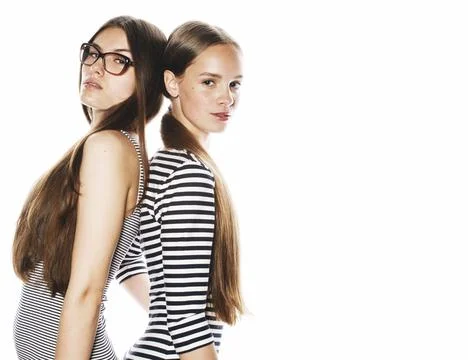 Two young workers isolated on white, same dresses in strip Stock Photos