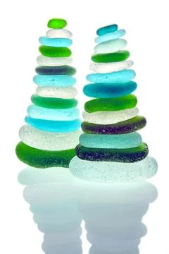 Two zen pyramids of balanced colored glass stones isolated on white background Stock Photos