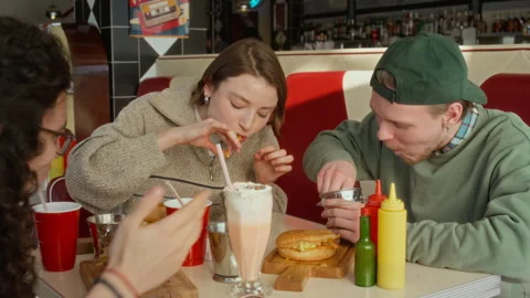 Two Zoomer Students Having Speed Eating Competition at Burger Diner Stock Footage 335757105