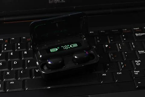 TWS or True Wireless Stereo at Black Notebook Stock Photos