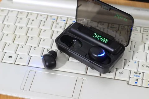 TWS or True Wireless Stereo at White Notebook Stock Photos