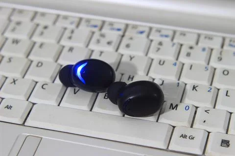 TWS or True Wireless Stereo at White Notebook Stock Photos