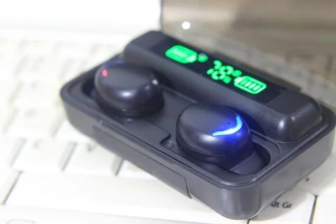 TWS or True Wireless Stereo at White Notebook Stock Photos