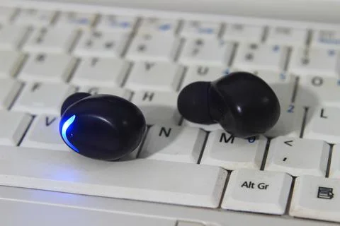 TWS or True Wireless Stereo at White Notebook Stock Photos