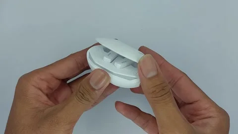 Tws or white lenovo wireless bluetooth earphones for listening to music Stock Footage 245492225
