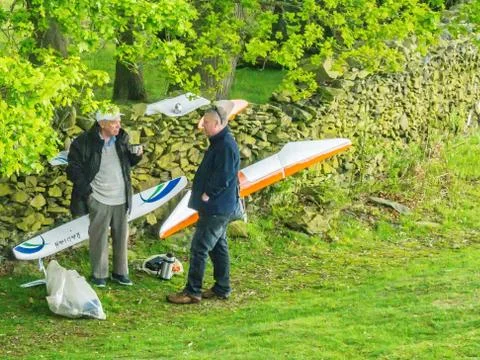 TwTwo men with model aircraft taking a breako men with model aircraft taking Stock Photos