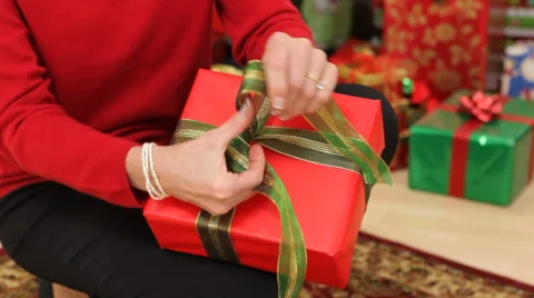Tying a box on Christmas present Video stock 61670947