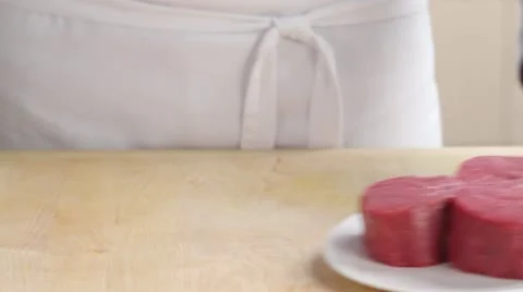 Tying fillet steaks with kitchen twine to retain shape Stock Footage 24665177