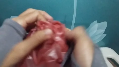 Tying a Plastic Bag Filled with Large Red Chili Peppers Stock Footage 229306127