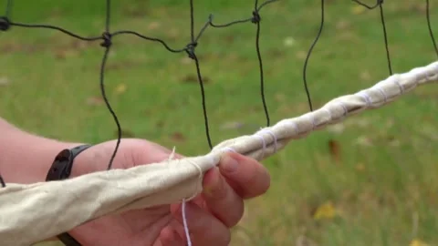 Tying String On A VolleyBall Net Stock Footage 156765438