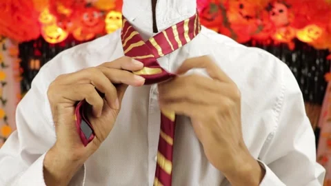 Tying a tie on halloween Stock Footage 242957799