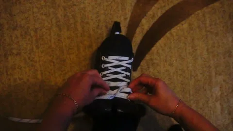 Tying the white laces on skates,preparing to go on the ice 스톡 동영상 85599782
